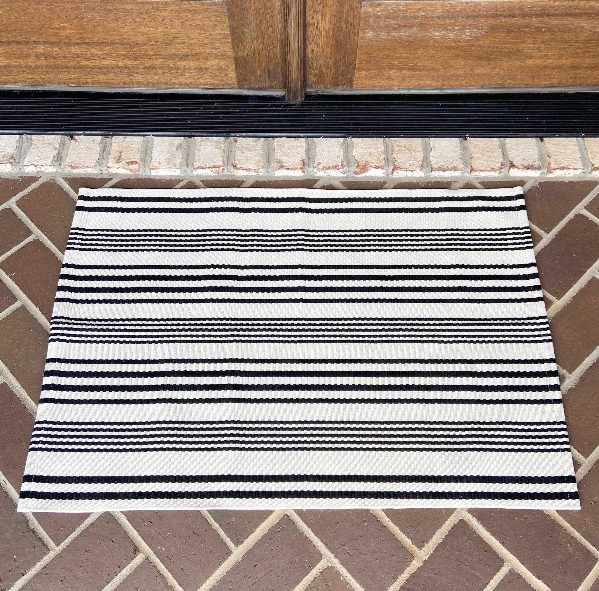 https://www.cottonandcrate.com/cdn/shop/products/rug-for-entry-doors-white-black-horizontal-stripes-woven-modern-farmhouse-rug_1024x1024@2x.jpg?v=1648651527